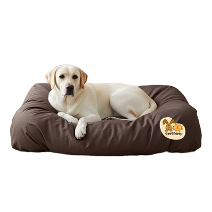 White labrador retriever resting on a bolster style dog bed covered with a brown PawSheets dog bed cover