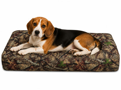 Dog lying on a water proof forest print dog bed with a white background